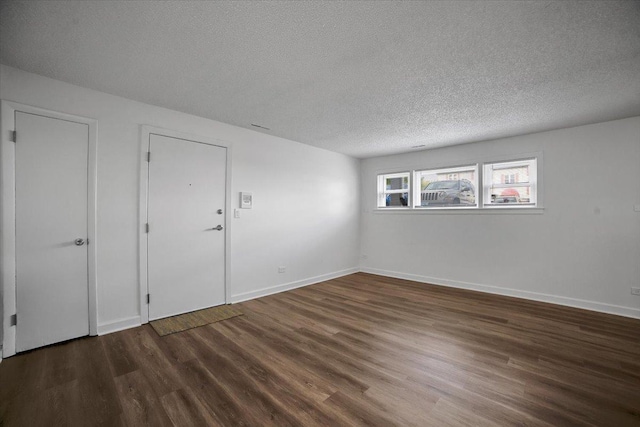9444 Kelvin Ln Unit A-3211, Schiller Park, IL 60176 - spare room featuring wood finished floors and a textured ceiling