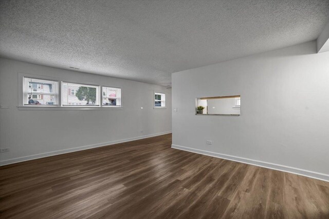 9444 Kelvin Ln Unit A-3211, Schiller Park, IL 60176 - spare room with dark wood-style flooring and a textured ceiling