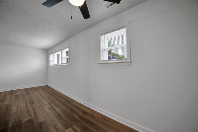 9444 Kelvin Ln Unit A-3211, Schiller Park, IL 60176 - spare room featuring dark wood-type flooring, a textured ceiling, and ceiling fan