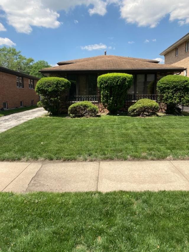 14238 S Manistee Ave, Burnham, IL 60633 - view of front of house with a front lawn and concrete driveway