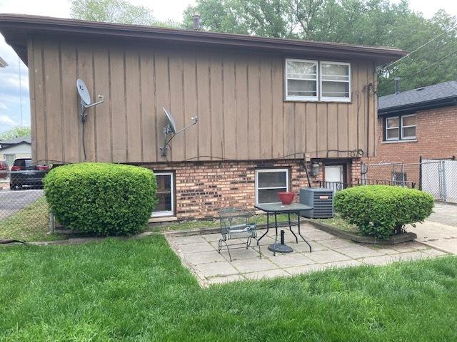14238 S Manistee Ave, Burnham, IL 60633 - back of property featuring brick siding, a patio area, and board and batten siding