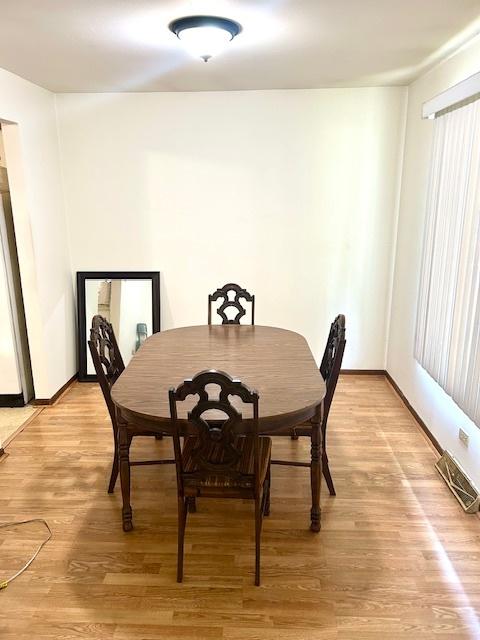 14238 S Manistee Ave, Burnham, IL 60633 - dining room with light wood-style floors and baseboards