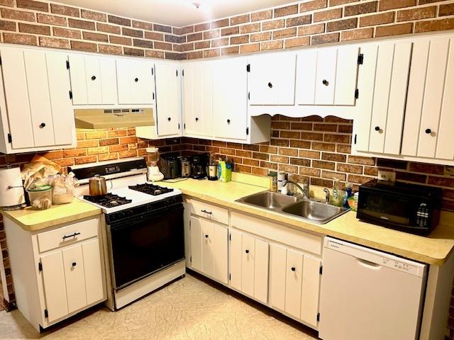 14238 S Manistee Ave, Burnham, IL 60633 - kitchen with white appliances, under cabinet range hood, backsplash, and light countertops