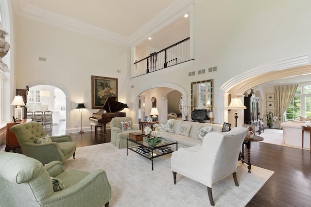 475 Red Fox Ln, Lake Forest, IL 60045 - living area with arched walkways, a high ceiling, crown molding, wood finished floors, and recessed lighting