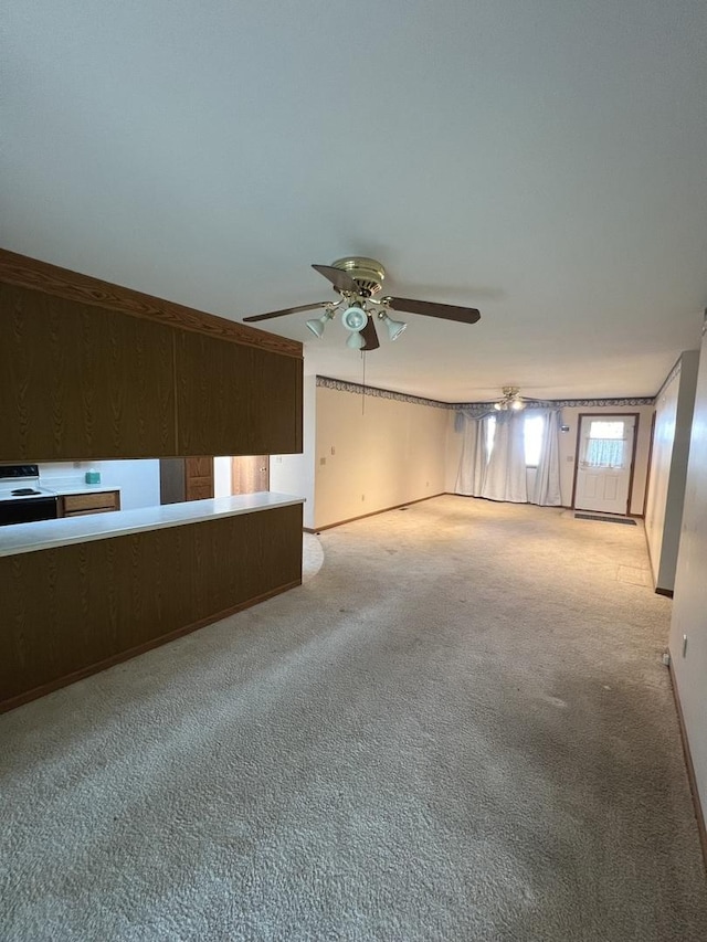 422 N 4th St, Cissna Park, IL 60924 - unfurnished living room with carpet floors and a ceiling fan