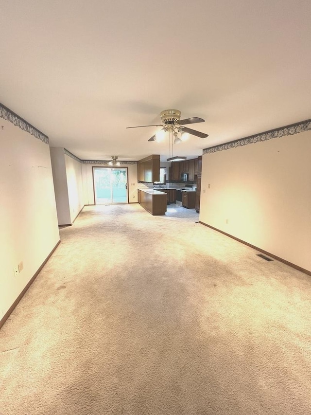 422 N 4th St, Cissna Park, IL 60924 - unfurnished living room with a ceiling fan and light colored carpet