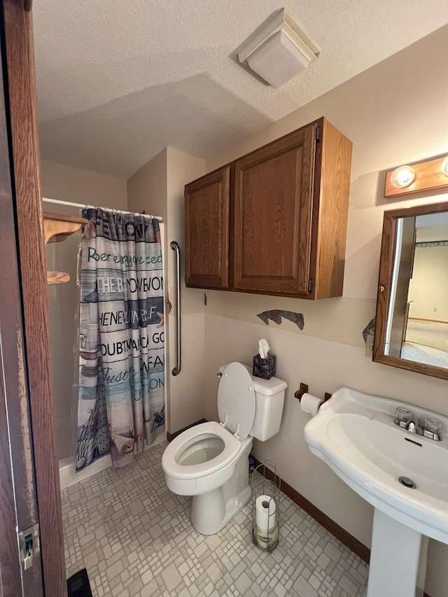 422 N 4th St, Cissna Park, IL 60924 - bathroom featuring toilet and a textured ceiling