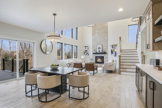 1104 Walter St, Lemont, IL 60439 - dining area featuring a fireplace, healthy amount of natural light, light wood-style floors, stairs, and recessed lighting