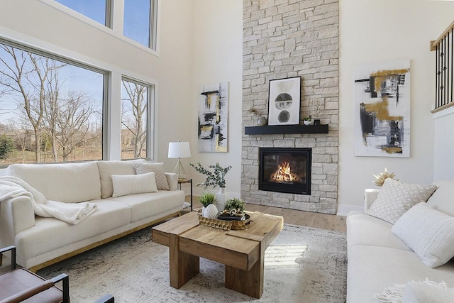 1104 Walter St, Lemont, IL 60439 - living room featuring a high ceiling, wood finished floors, and a stone fireplace