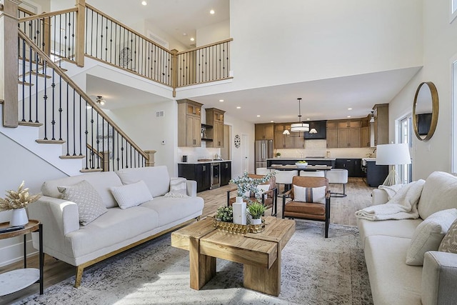 1104 Walter St, Lemont, IL 60439 - living area with a high ceiling, light wood-type flooring, stairs, recessed lighting, and a chandelier