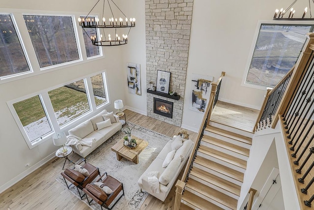 1104 Walter St, Lemont, IL 60439 - living area featuring a chandelier, wood finished floors, stairway, a high ceiling, and a fireplace