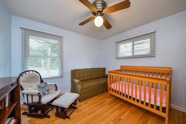 131 N Pierce Ave, Wheaton, IL 60187 - bedroom with wood finished floors, a crib, and a ceiling fan