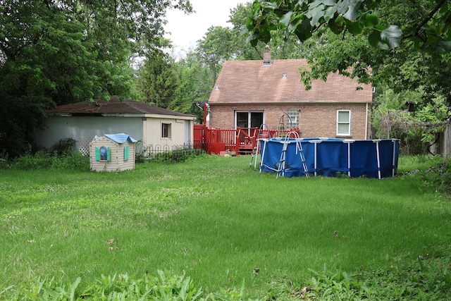 6807 S 79th Ave, Bridgeview, IL 60455 - view of grassy yard with an outdoor pool, a wooden deck, and an outdoor structure