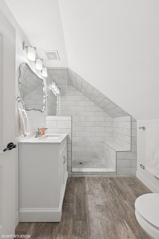 304 Bryant Ave, Glen Ellyn, IL 60137 - full bathroom with wood finished floors, vanity, and tiled shower