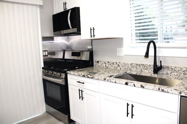 3042 Bar Harbour Rd, Aurora, IL 60504 - kitchen with stainless steel gas range oven, black microwave, and white cabinets
