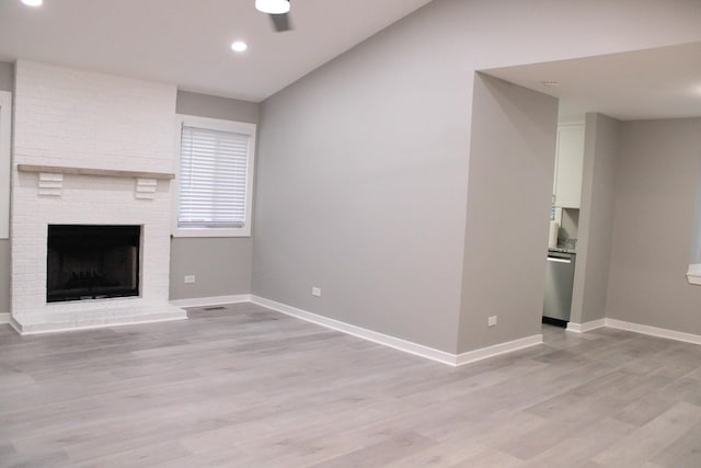 3042 Bar Harbour Rd, Aurora, IL 60504 - unfurnished living room featuring light wood-type flooring, a ceiling fan, a fireplace, recessed lighting, and vaulted ceiling