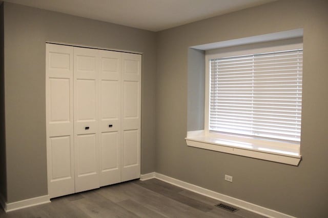 3042 Bar Harbour Rd, Aurora, IL 60504 - unfurnished bedroom with dark wood-style flooring and a closet