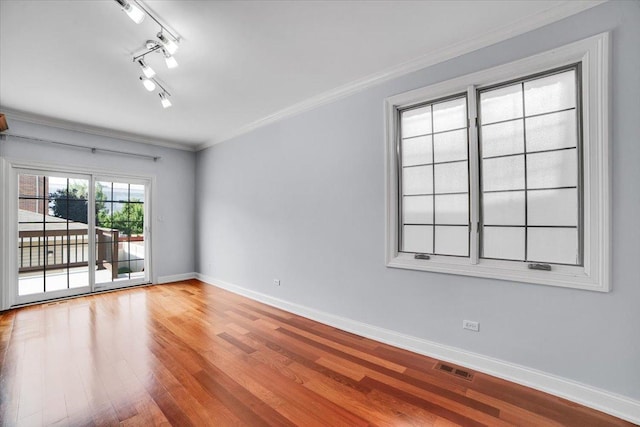 6825 W 64th Pl, Chicago, IL 60638 - unfurnished room featuring wood finished floors, ornamental molding, and rail lighting