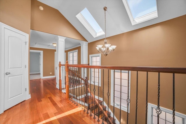 6825 W 64th Pl, Chicago, IL 60638 - hallway with a skylight, a chandelier, an upstairs landing, wood finished floors, and high vaulted ceiling