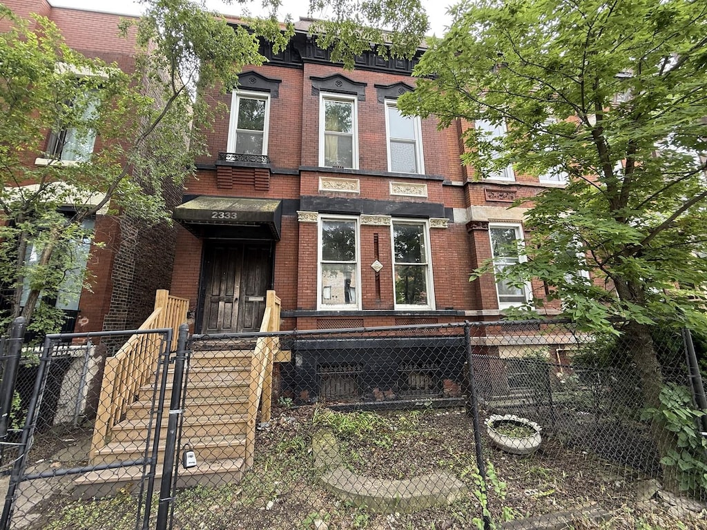 2333 W Warren Blvd, Chicago, IL 60612 - italianate-style house featuring brick siding, a fenced front yard, and a gate