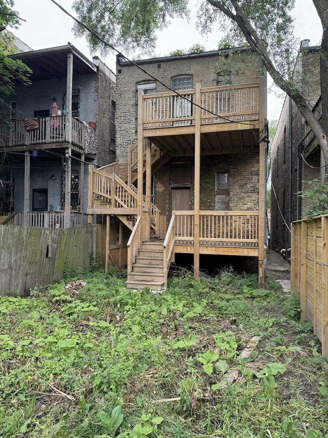 2333 W Warren Blvd, Chicago, IL 60612 - rear view of house featuring stairway, brick siding, and a wooden deck