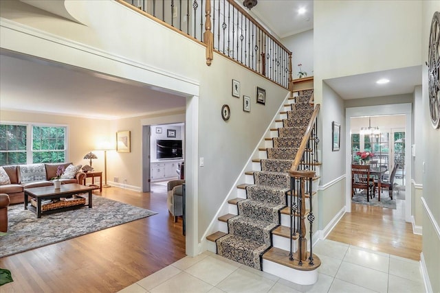 1490 S Ridge Rd, Lake Forest, IL 60045 - stairway featuring tile patterned flooring, ornamental molding, and a towering ceiling