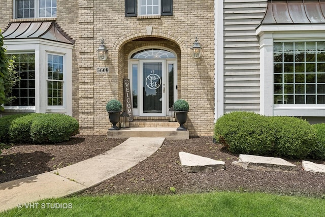 5609 Farmbrook Ln, Crystal Lake, IL 60014 - property entrance with a standing seam roof, brick siding, and a metal roof
