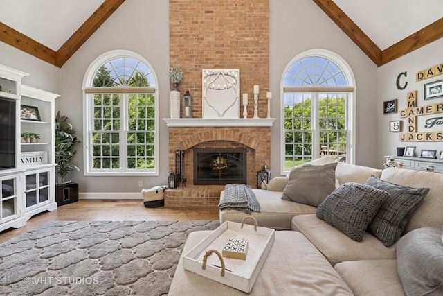 5609 Farmbrook Ln, Crystal Lake, IL 60014 - living room featuring high vaulted ceiling, beamed ceiling, wood finished floors, a fireplace, and healthy amount of natural light