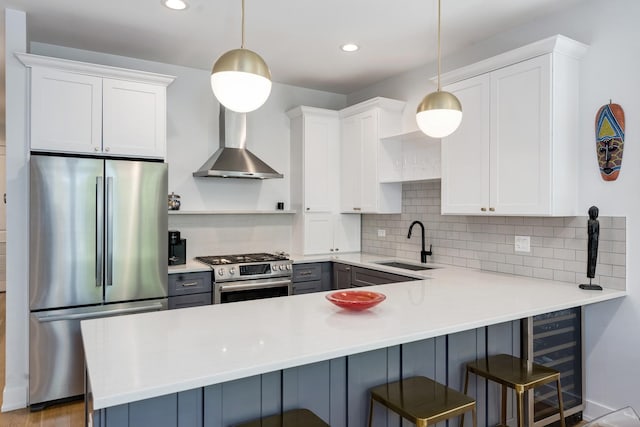 879 N Hermitage Ave Unit 2, Chicago, IL 60622 - kitchen with stainless steel appliances, wine cooler, decorative backsplash, a peninsula, and light countertops