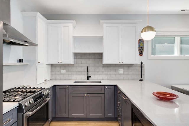 879 N Hermitage Ave Unit 2, Chicago, IL 60622 - kitchen featuring stainless steel range with gas stovetop, wall chimney exhaust hood, white cabinetry, and gray cabinets