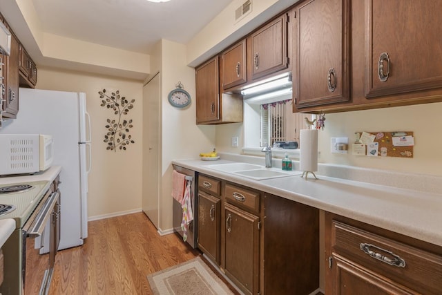 740 Saint Andrews Ln Unit 13, Crystal Lake, IL 60014 - kitchen with light wood-type flooring, white appliances, and light countertops