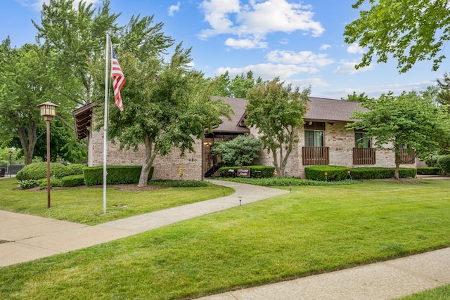 740 Saint Andrews Ln Unit 13, Crystal Lake, IL 60014 - obstructed view of property with a front lawn, brick siding, and a shingled roof