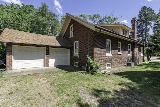 1128 Shiloh Blvd, Zion, IL 60099 - view of side of property featuring a chimney, a lawn, brick siding, and an attached garage