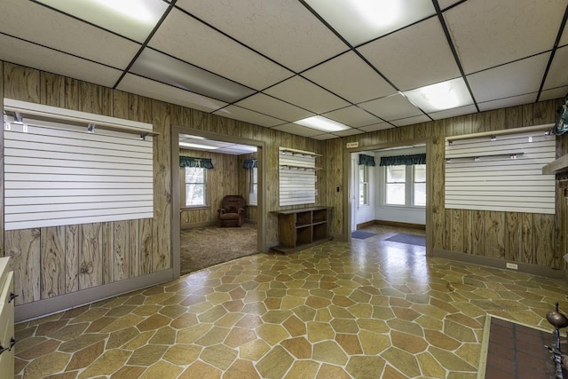 1128 Shiloh Blvd, Zion, IL 60099 - empty room featuring a paneled ceiling, stone floors, and wood walls