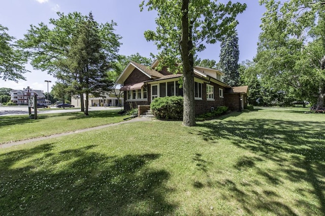 1128 Shiloh Blvd, Zion, IL 60099 - view of front facade featuring a front yard, a sunroom, and brick siding