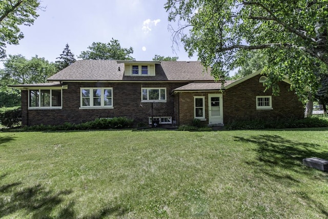 1128 Shiloh Blvd, Zion, IL 60099 - tri-level home featuring brick siding, a front yard, and a shingled roof
