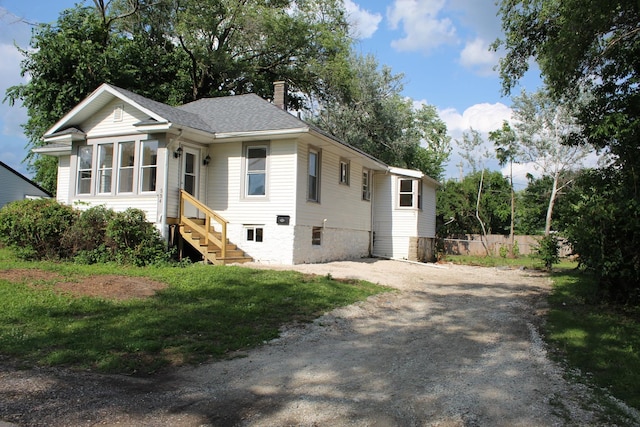 534 Mohawk St, Joliet, IL 60432 - view of front of house with a chimney, entry steps, and roof with shingles