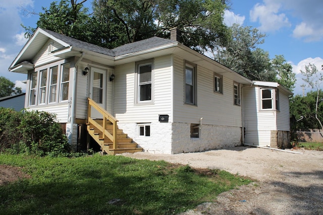 534 Mohawk St, Joliet, IL 60432 - view of front of property featuring a chimney, entry steps, and roof with shingles
