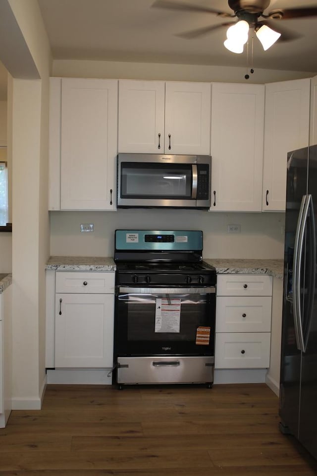 534 Mohawk St, Joliet, IL 60432 - kitchen with stainless steel appliances, dark wood-style flooring, and white cabinetry
