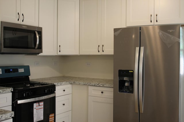 534 Mohawk St, Joliet, IL 60432 - kitchen with stainless steel appliances, white cabinets, and light stone countertops
