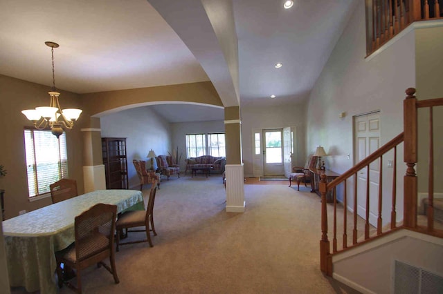 1437 Sage Dr, Bolingbrook, IL 60490 - dining area featuring arched walkways, light colored carpet, a chandelier, recessed lighting, and stairway