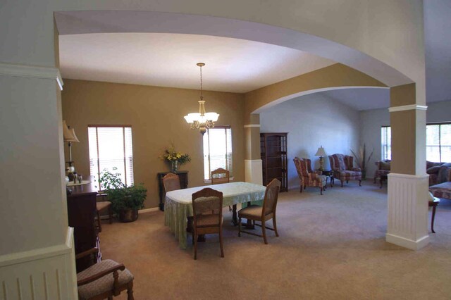 1437 Sage Dr, Bolingbrook, IL 60490 - dining space with arched walkways, light carpet, and a chandelier
