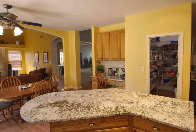 1437 Sage Dr, Bolingbrook, IL 60490 - kitchen with ceiling fan, arched walkways, light stone countertops, and open floor plan