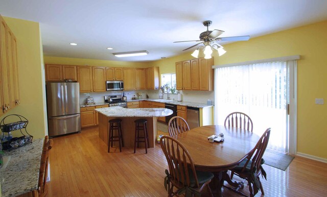 1437 Sage Dr, Bolingbrook, IL 60490 - kitchen with stainless steel appliances, a kitchen island, ceiling fan, recessed lighting, and light wood finished floors