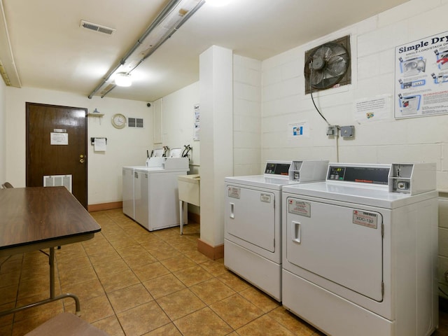 9395 Landings Ln Unit 406, Des Plaines, IL 60016 - community laundry room with washer and clothes dryer and light tile patterned floors
