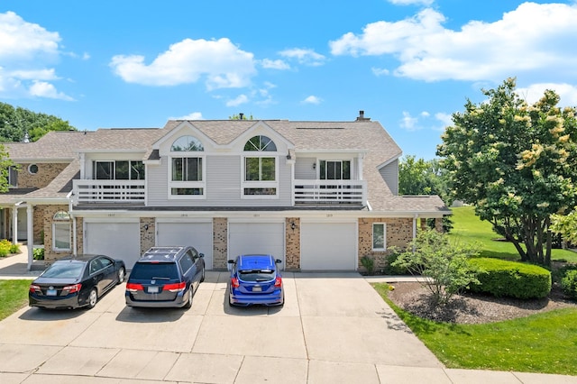 1211 Ranchview Ct Unit 1211, Buffalo Grove, IL 60089 - multi unit property featuring driveway, an attached garage, brick siding, and a shingled roof