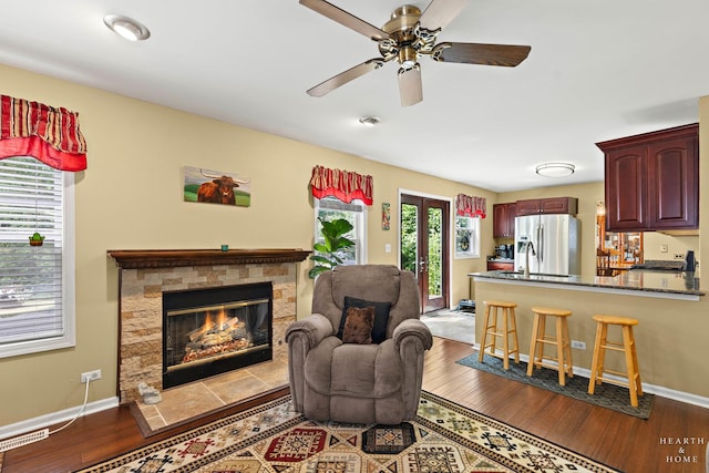 4091/2 Concord Ave, Fox River Grove, IL 60021 - living room featuring a stone fireplace, dark wood-style flooring, and a ceiling fan