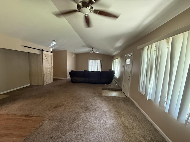 1006 Totem Trl, Mchenry, IL 60051 - carpeted living room with a barn door, a ceiling fan, and vaulted ceiling