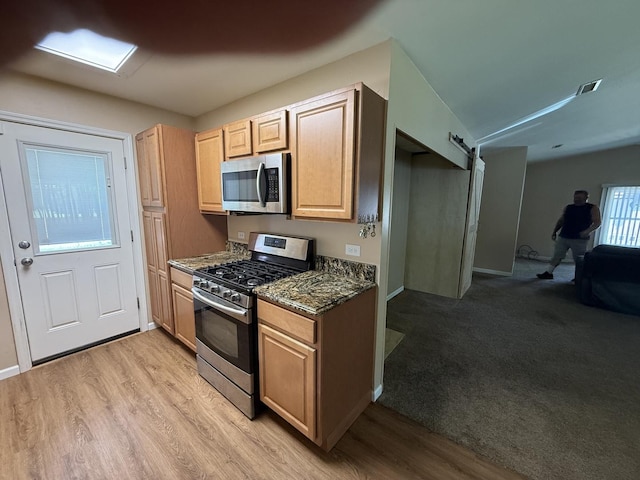 1006 Totem Trl, Mchenry, IL 60051 - kitchen featuring appliances with stainless steel finishes, open floor plan, light wood finished floors, and light brown cabinetry