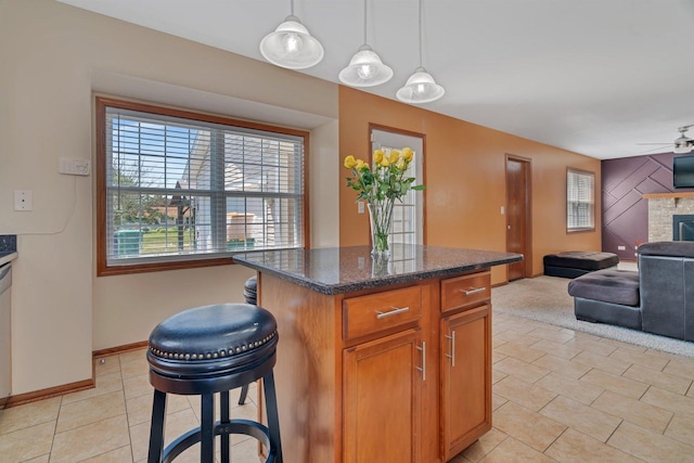 4218 Glenlo Dr, Plainfield, IL 60586 - kitchen with open floor plan, ceiling fan, decorative light fixtures, a center island, and a fireplace